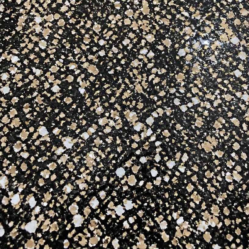Black epoxy flake floor with gold and white chips